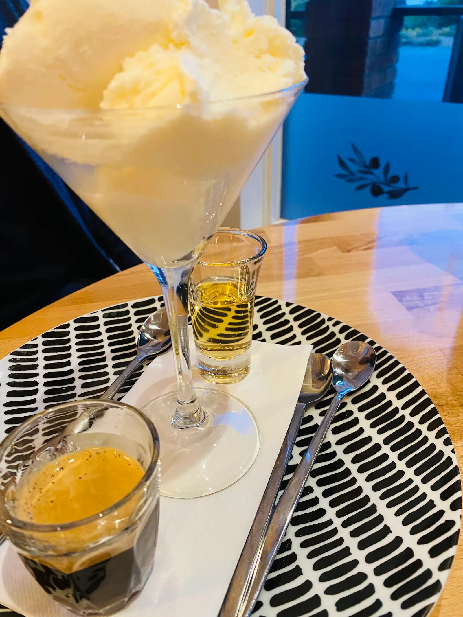 Affogato dessert with gelato, espresso and liqueur on patterned ceramic plate